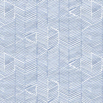 Detail of fabric in a dense herringbone print in blue on a white field.