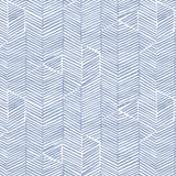 Detail of fabric in a dense herringbone print in blue on a white field.