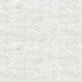 Detail of fabric in a dense herringbone print in light gray on a white field.