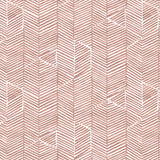 Detail of fabric in a dense herringbone print in brown on a white field.