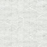 Detail of fabric in a dense herringbone print in light green on a white field.