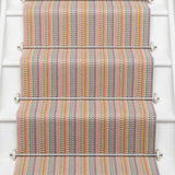 Striped flatweave runner in tan blue green on white staircase