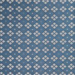 Woven fabric with ornate diamond design with cream accents on blue.