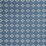 Woven fabric with ornate diamond design with cream accents on blue.