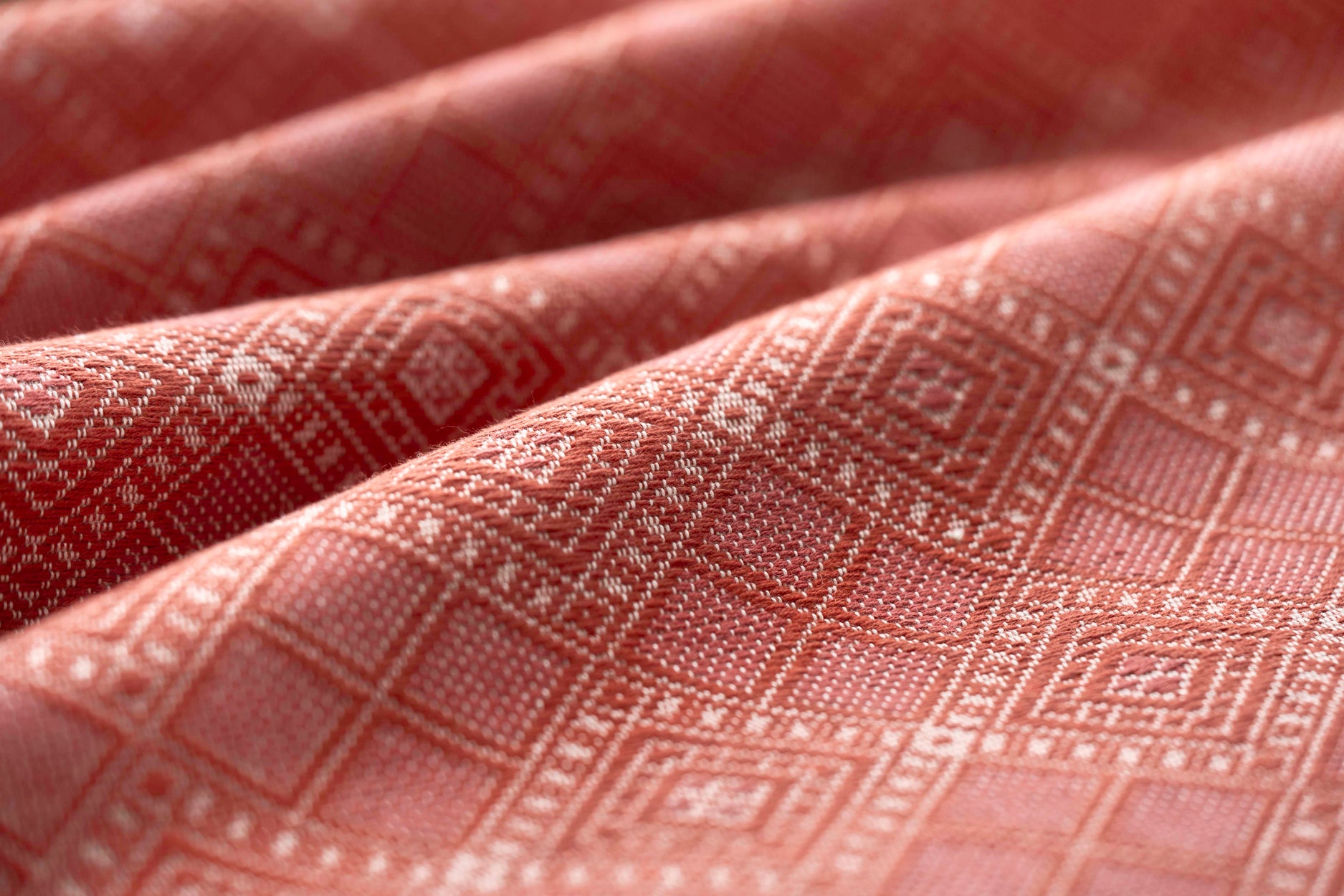 Close-up of red fabric with a diamond pattern