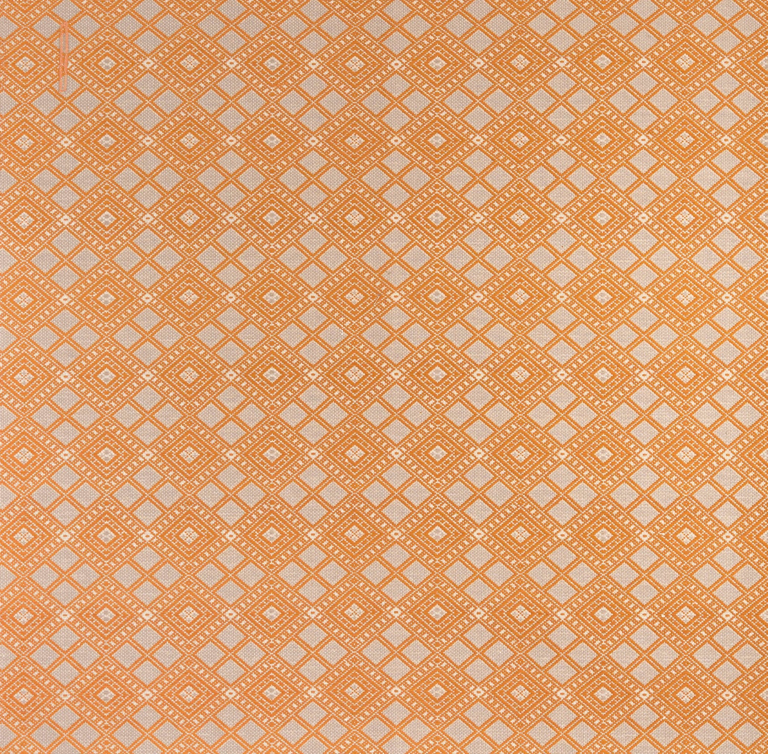Woven fabric with ornate diamond design with cream accents on orange. 