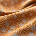 Close-up of textured yellow and white fabric with geometric pattern