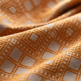 Close-up of textured yellow and white fabric with geometric pattern