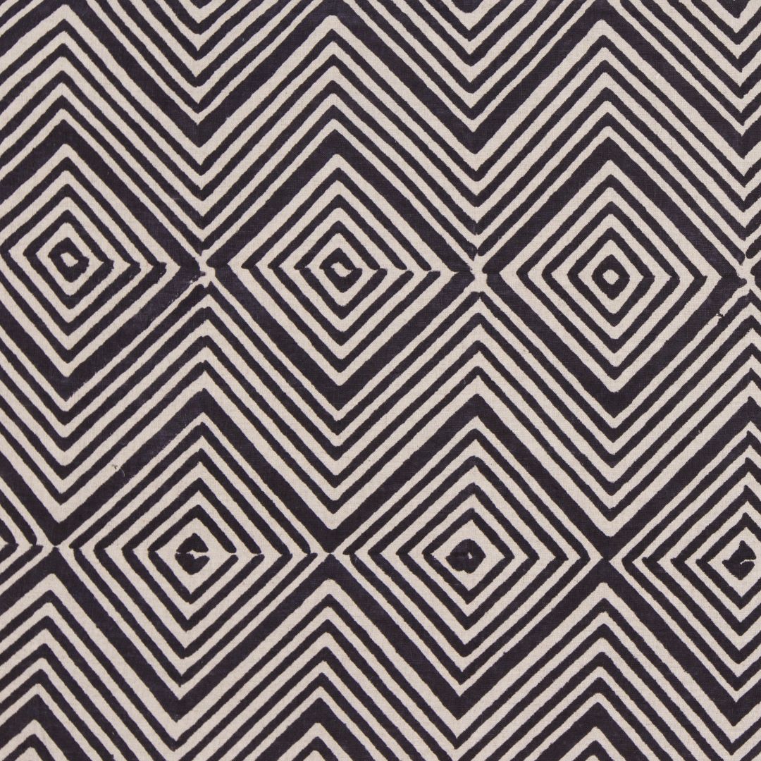 Detail of fabric in an abstract diamond print in black on a greige field.
