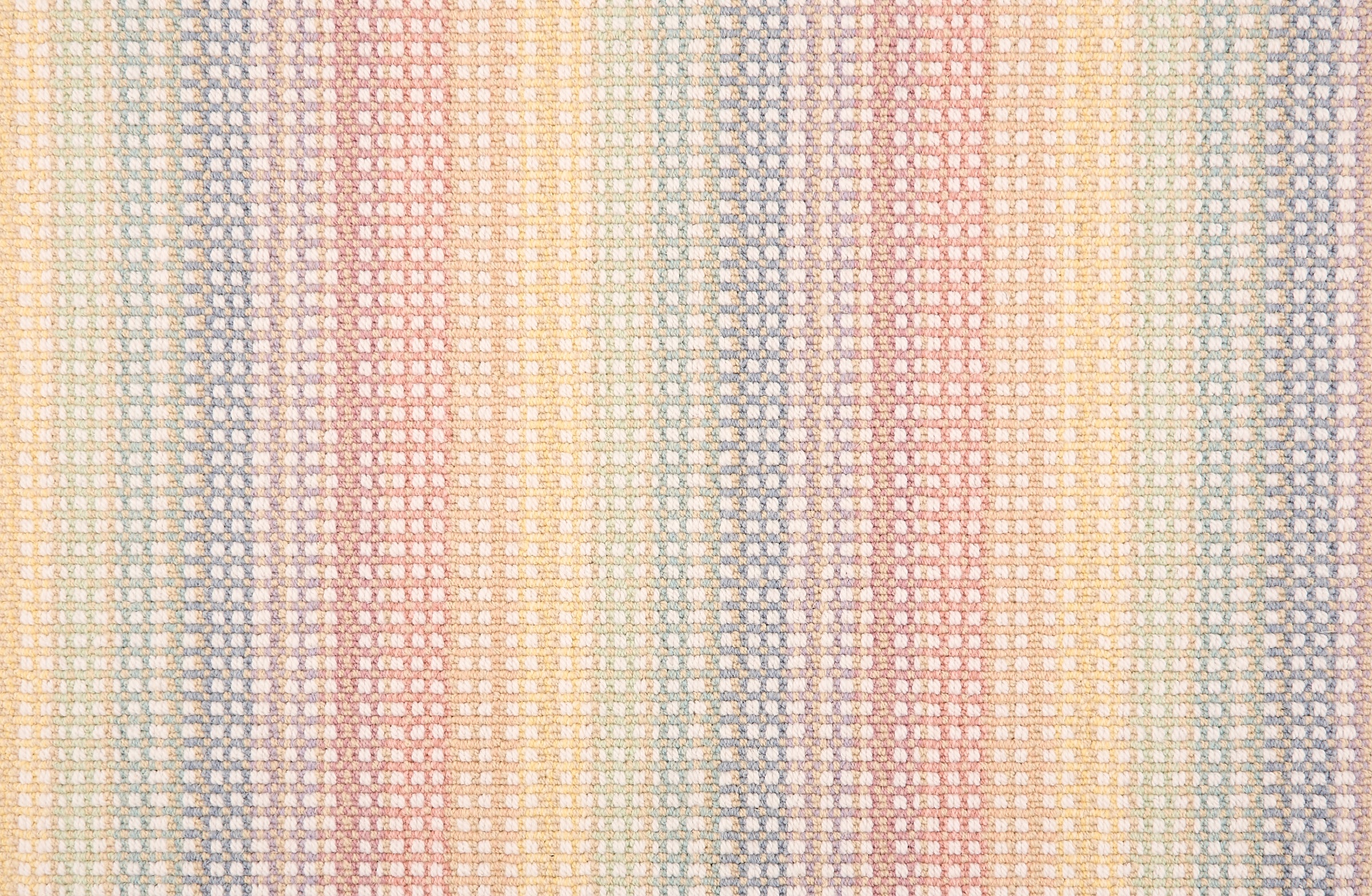 Broadloom carpet in a textural multi color stripe in a pastel rainbow palette.