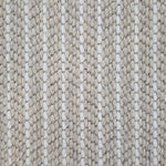 Close-up of a broadloom carpet with vertical stripes in beige and white.