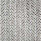 Close-up of a broadloom carpet with vertical stripes in beige and white