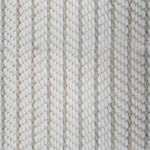 Close-up of a broadloom carpet with vertical stripes in beige and tan