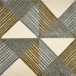 Close-up of a geometric patterned rug with triangles and stripes in green and blue.