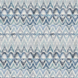 Detail of fabric in a painterly ikat print in shades of blue and navy on a white field.