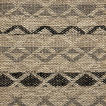 Handwoven rug detail in a lattice stripe design in black and grey
