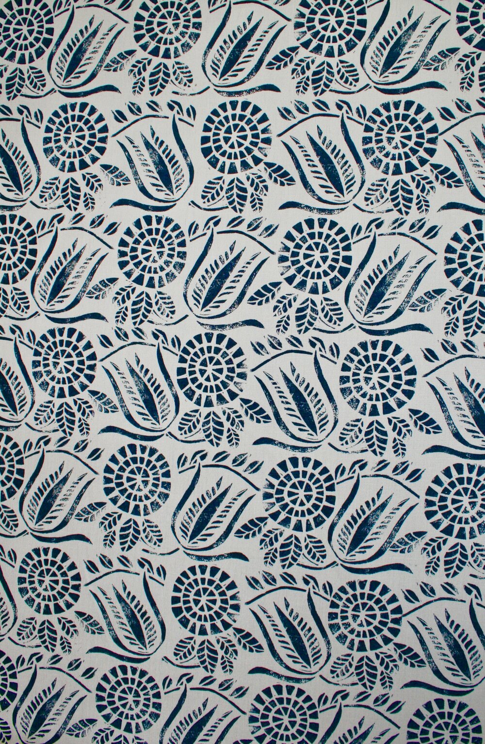 Close-up of fabric in a dense floral print in navy on a white field.