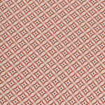 Detail of woven fabric in a geometric grid print in red and navy on a cream field.