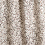 Draped fabric with small scale coral design in dark brown on white. 