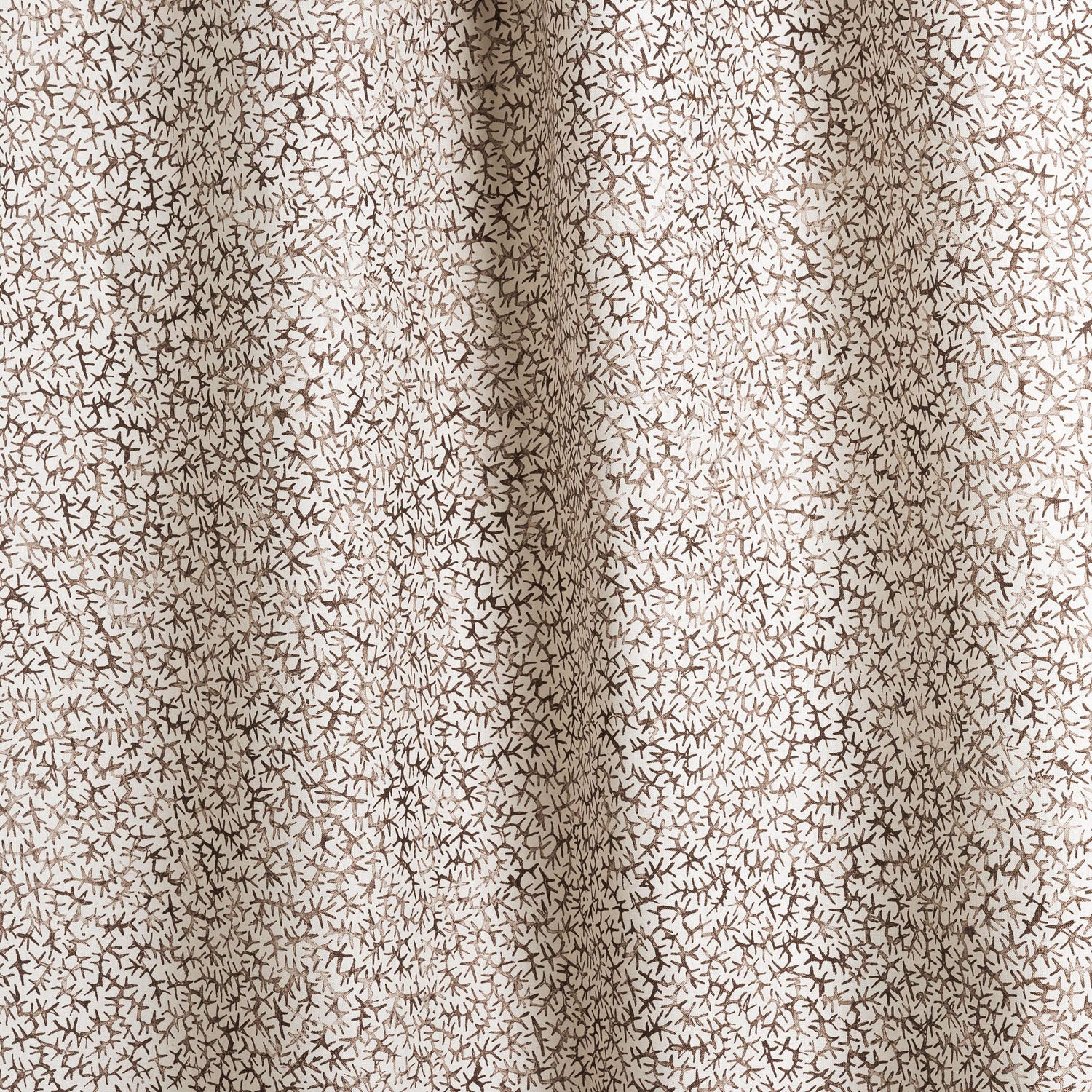 Draped fabric with small scale coral design in dark brown on white. 