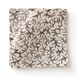 Fabric swatch with small scale coral design in dark brown on white. 