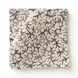 Fabric swatch with small scale coral design in dark brown on white. 
