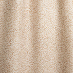 Draped fabric with small scale coral design in warm tan on white. 