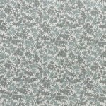 Printed linen fabric in a repeating bamboo leaf pattern in shades of green on a white field.