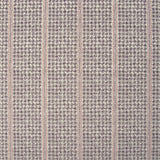 Detail of fabric in a dense repeating stripe and star print in purple on a tan field.