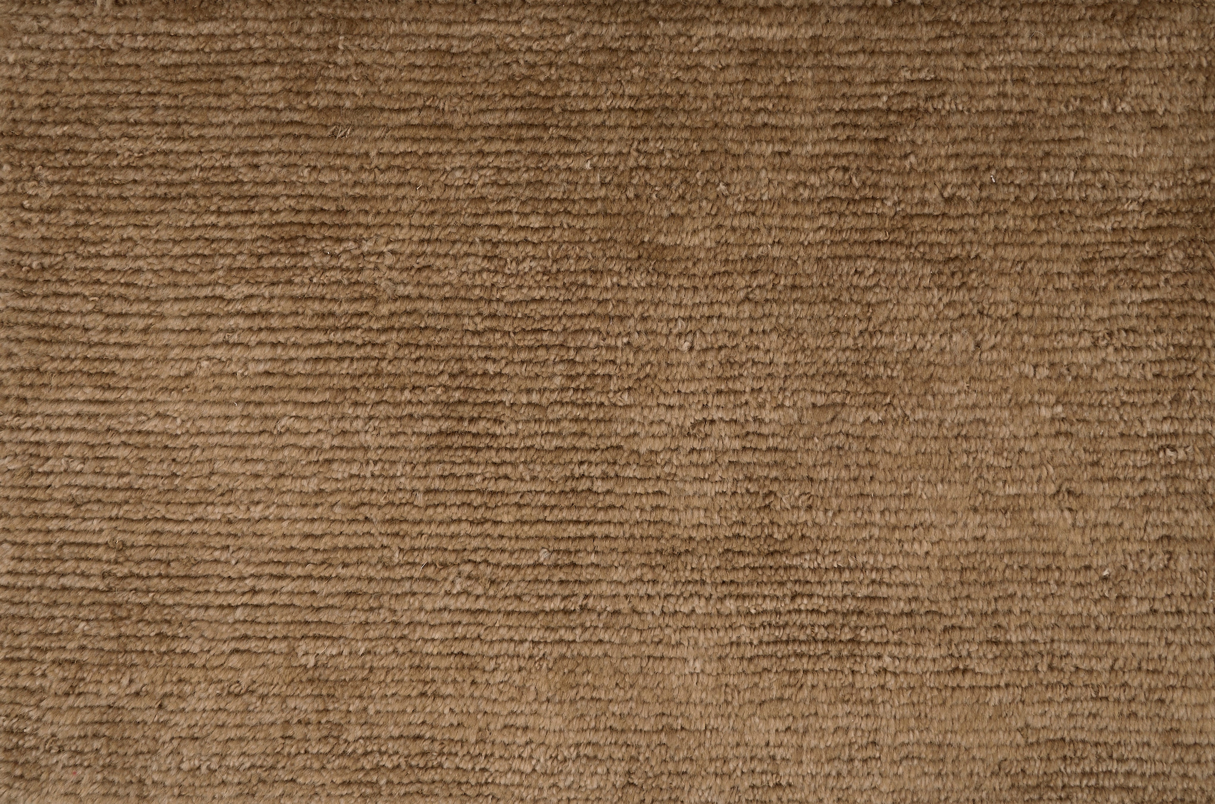 Broadloom carpet solid ribbed cut pile in warm brown.