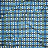 A close-up of a woven fabric pattern featuring intersecting vertical and horizontal stripes in navy blue, medium blue, light blue, olive green, and white.