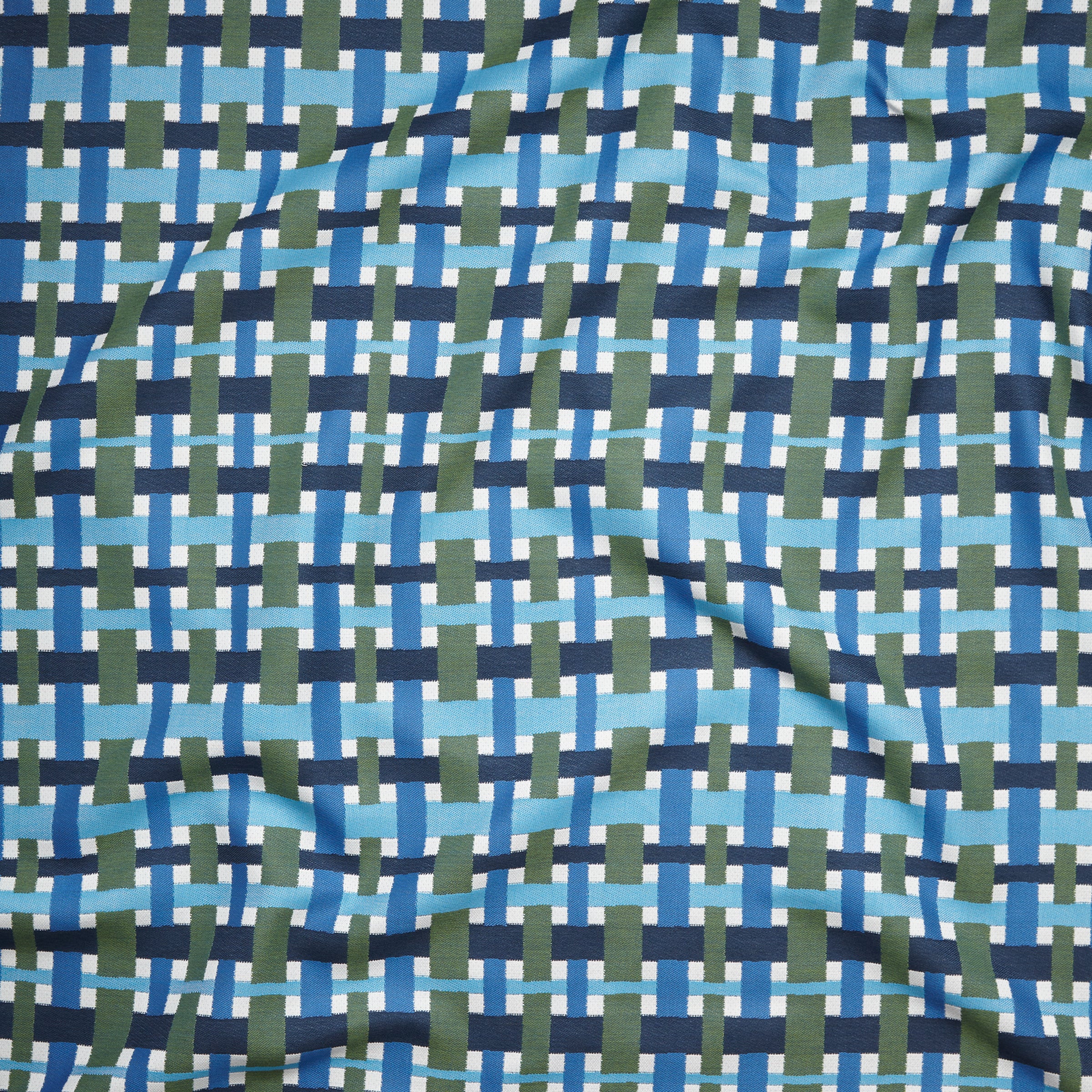 A close-up of a woven fabric pattern featuring intersecting vertical and horizontal stripes in navy blue, medium blue, light blue, olive green, and white.