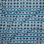 Close up of printed linen with graphic plaid pattern in shades of light blue, denim and navy blue.