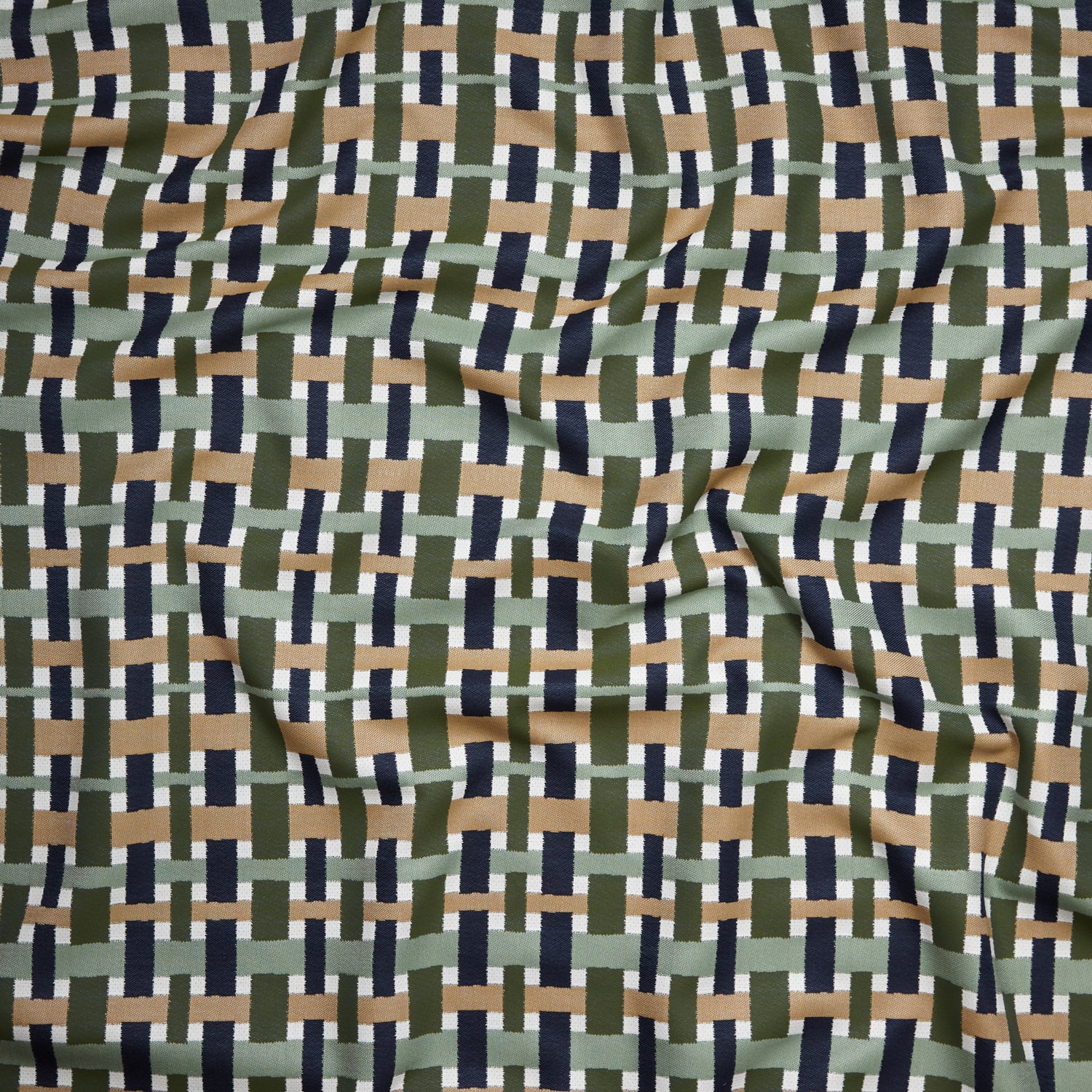 Close up of gently draped woven Indoor-Outdoor fabric with graphic plaid pattern in green, tan, sage green and grass green.
