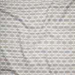 Close up of gently draped woven Indoor-Outdoor fabric with graphic plaid pattern in neutral tones. 