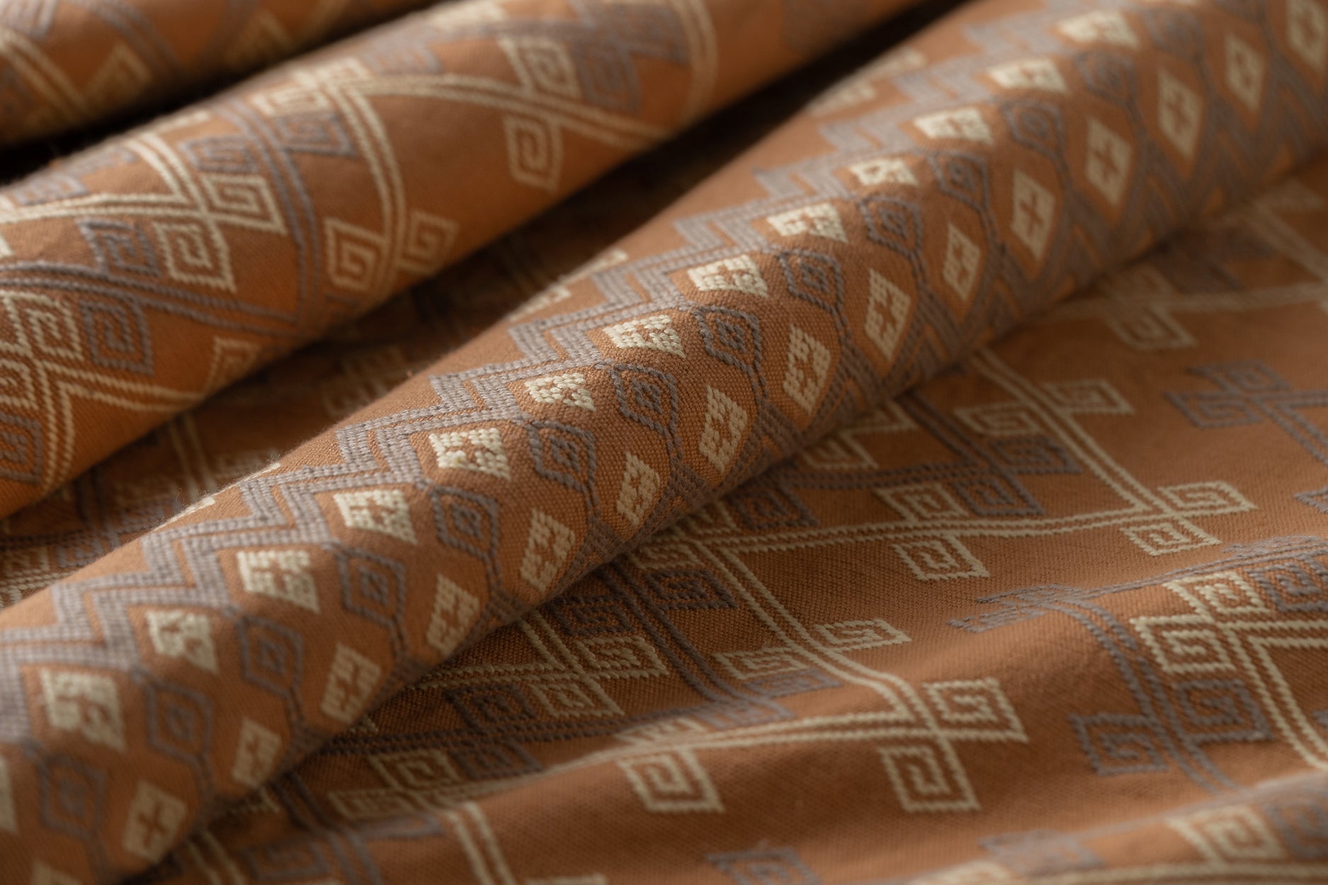 Brown fabric with geometric pattern lightly folded