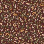 Patterned wallpaper with abstract floral design in green, yellow and pale pink on a crimson field. 