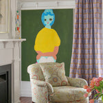 Living room interior with white fire place mantle.  pastel floral upholstered arm chair against a painting of a woman's abstracted figure on a green field with a purple geometric curtain.