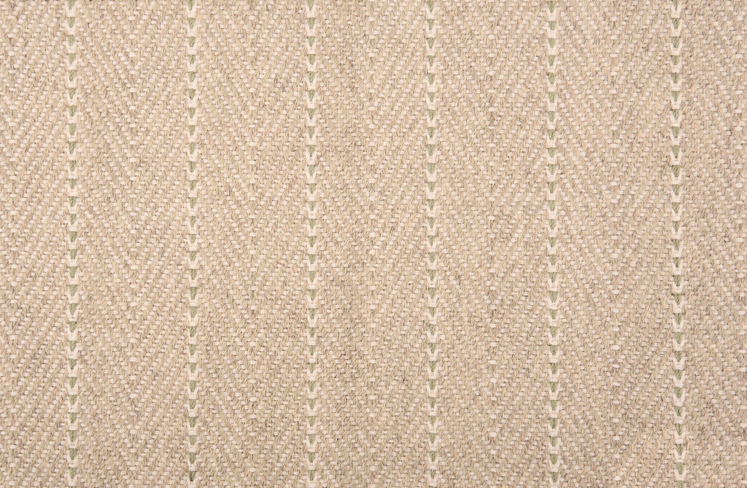 Broadloom carpet in a herringbone pattern in ecru with a sage green stripe accent.