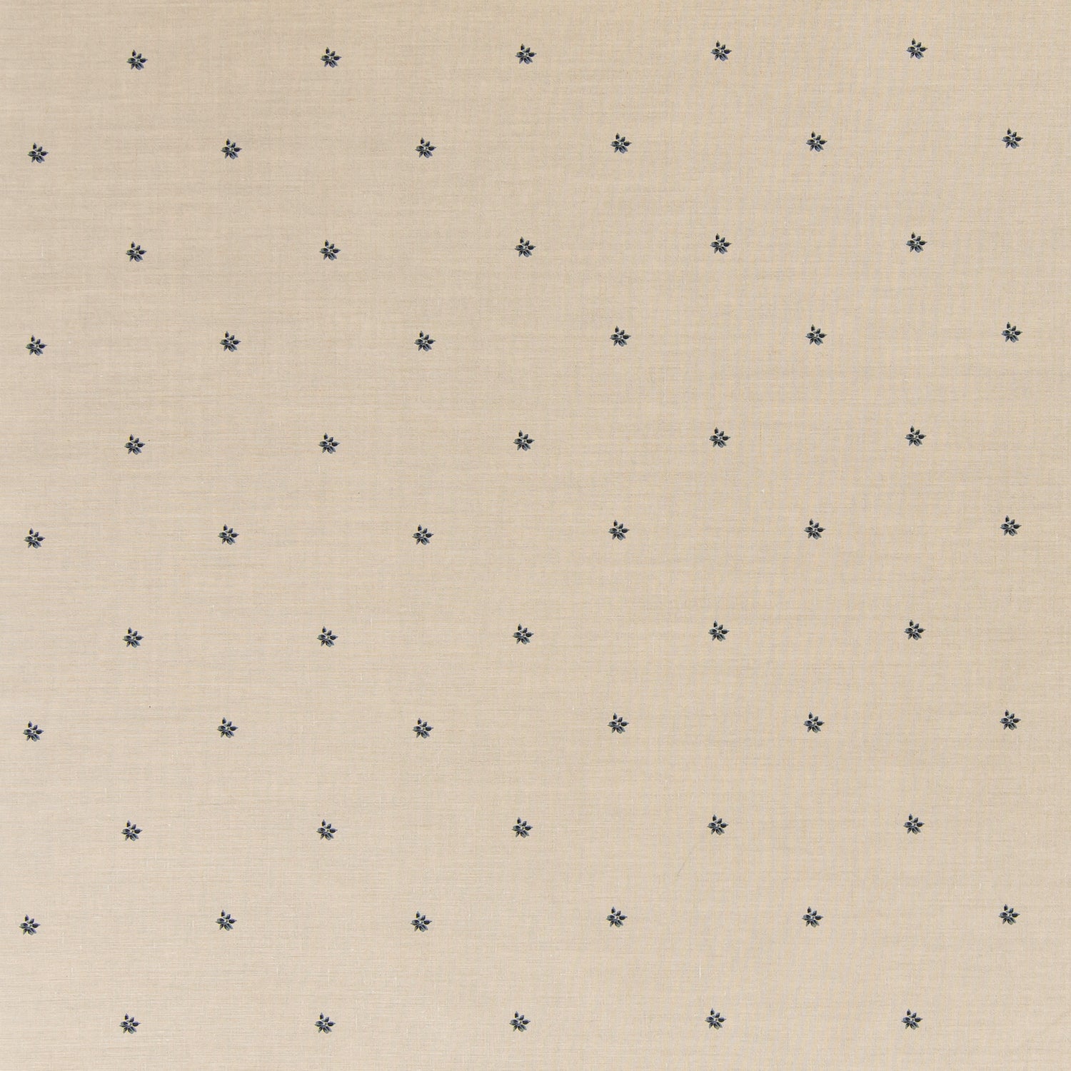 Printed linen fabric in a repeating small-scale flower pattern in navy on a cream field.