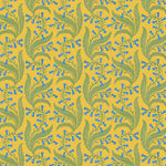 Wallpaper in a scrolling floral pattern in blue and green on a yellow field. 