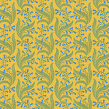 Wallpaper in a scrolling floral pattern in blue and green on a yellow field. 