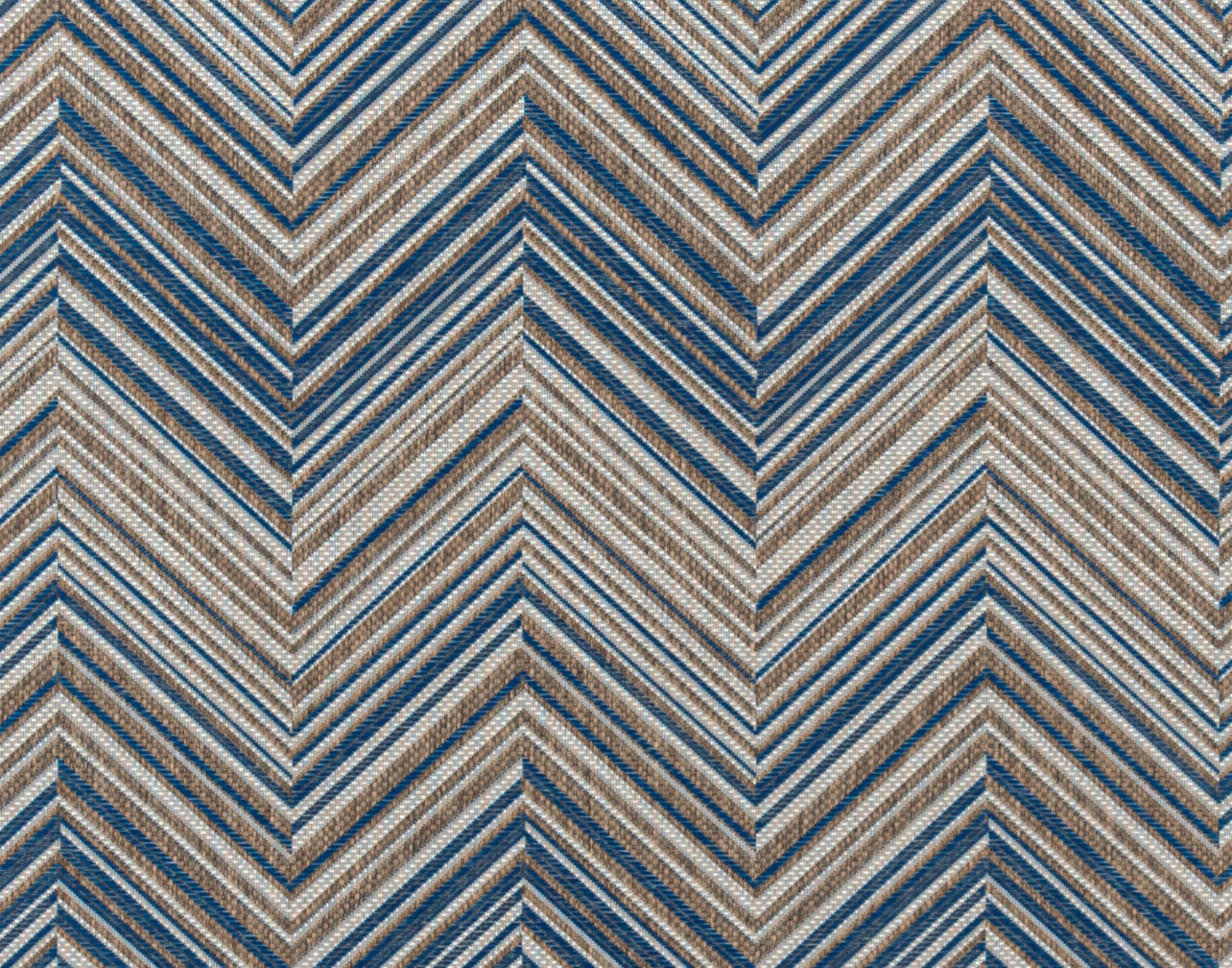 Broadloom carpet in a bold chevron pattern in shades of white, brown and marine blue.