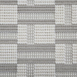 Broadloom carpet in a complex checkerboard pattern in ivory and light grey.
