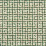 Detail of fabric in a circular floral print in light green and white on a mottled green field.