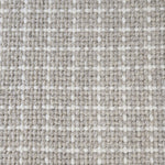 Close-up of a carpet with a textured check pattern in grey and white.