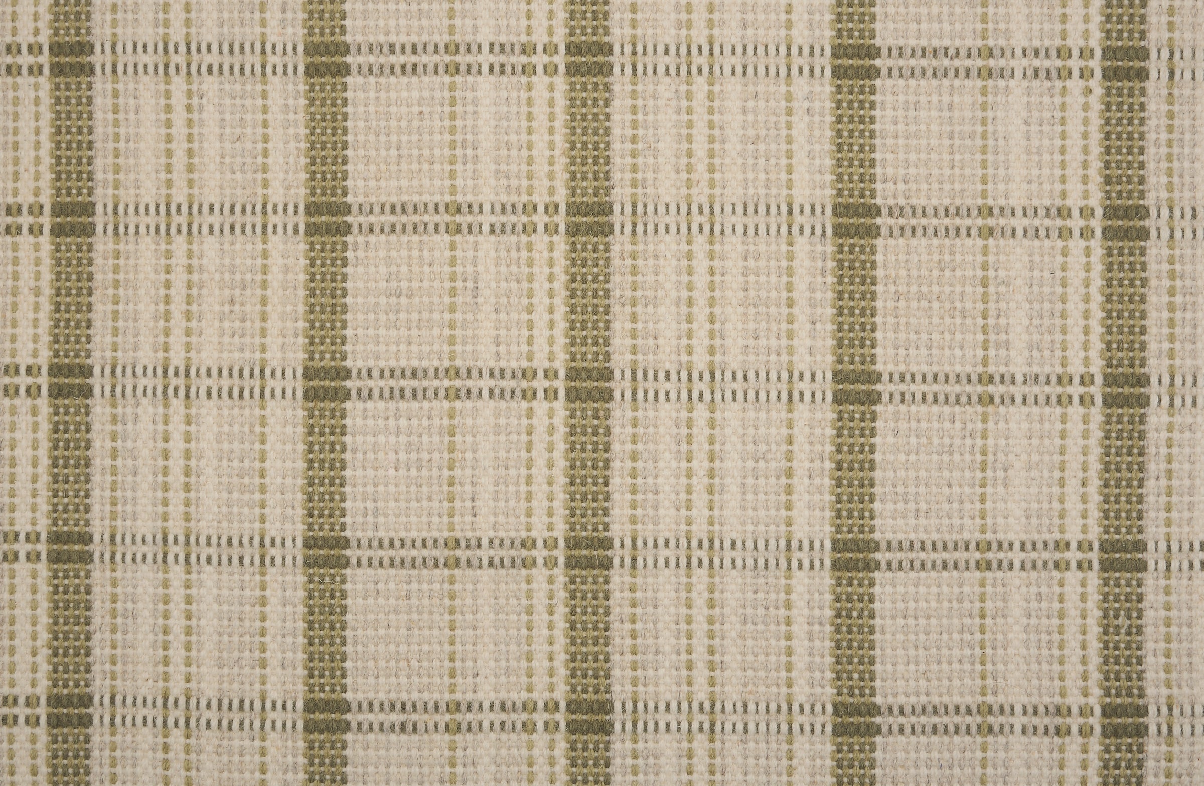 Broadloom carpet in a windowpane plaid in cream and sage green.