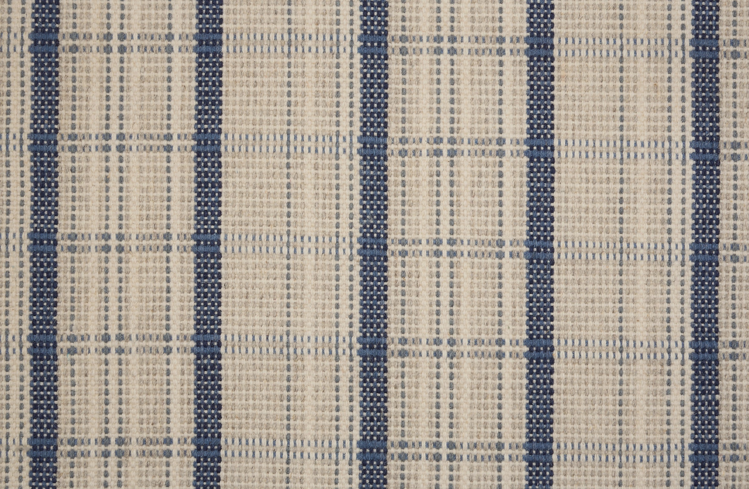 Broadloom carpet in a windowpane plaid in cream and blue.