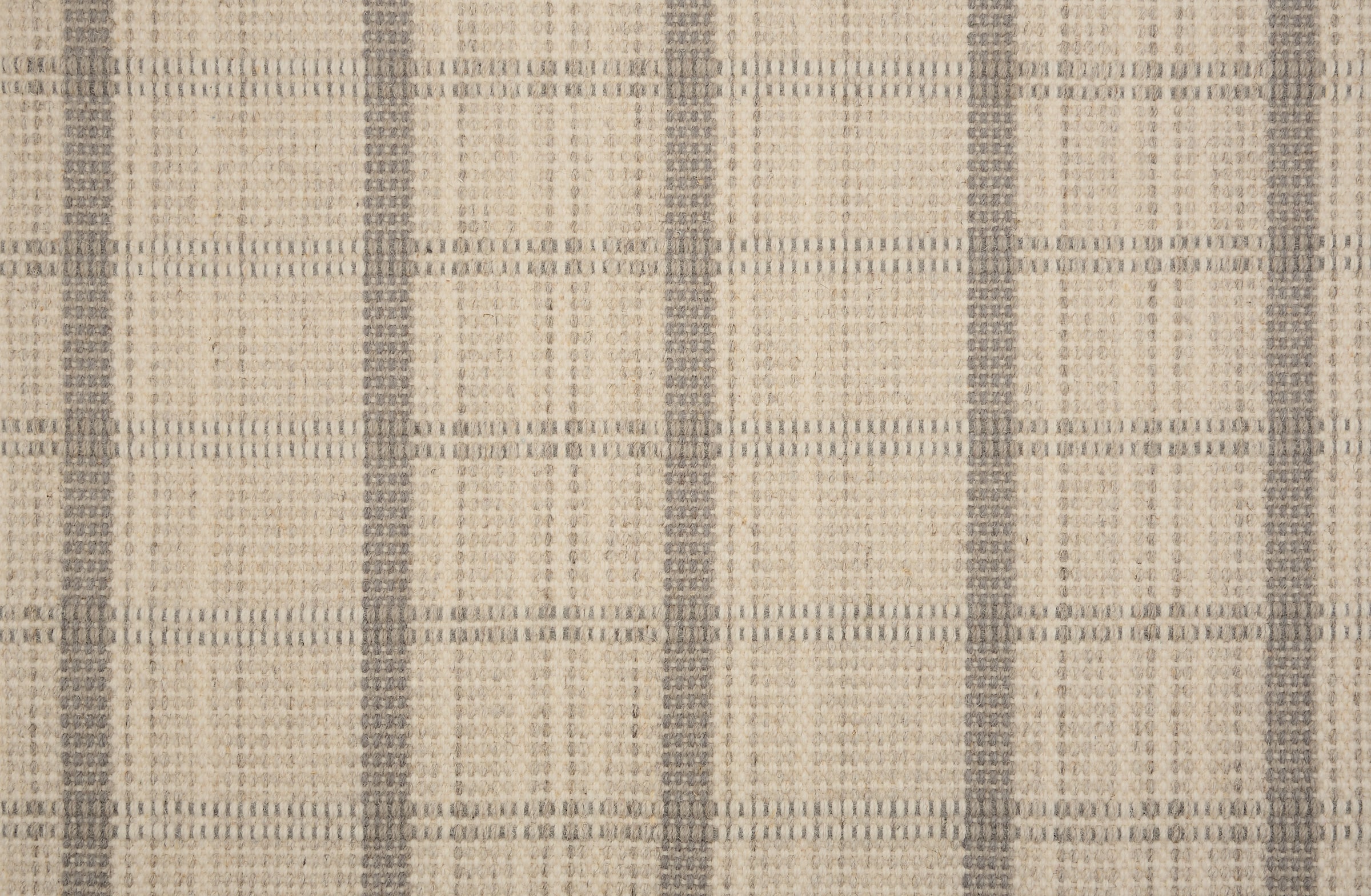 Broadloom carpet in a windowpane plaid in cream and grey.