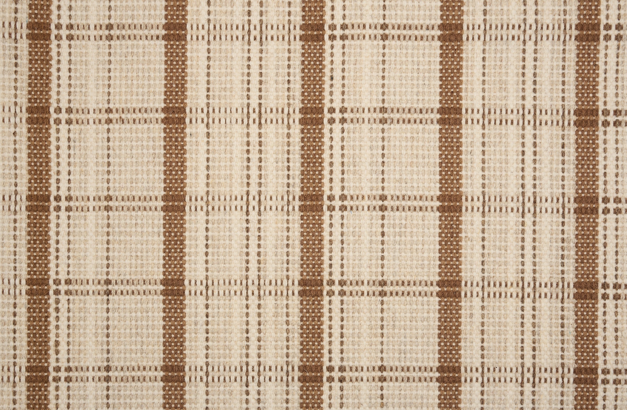 Broadloom carpet in a windowpane plaid in cream and warm brown.